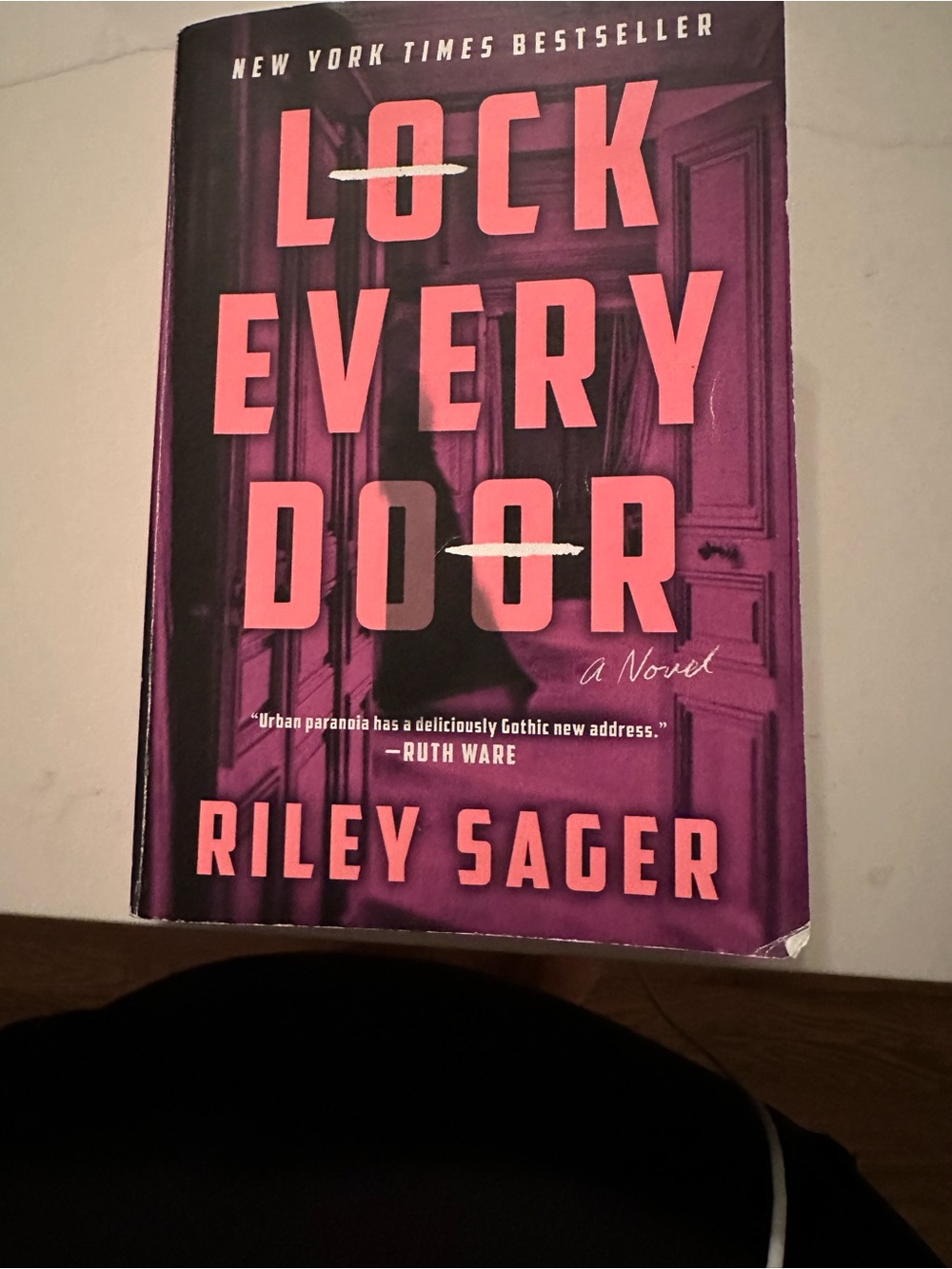 Lock every door paperback book by Riley Sager